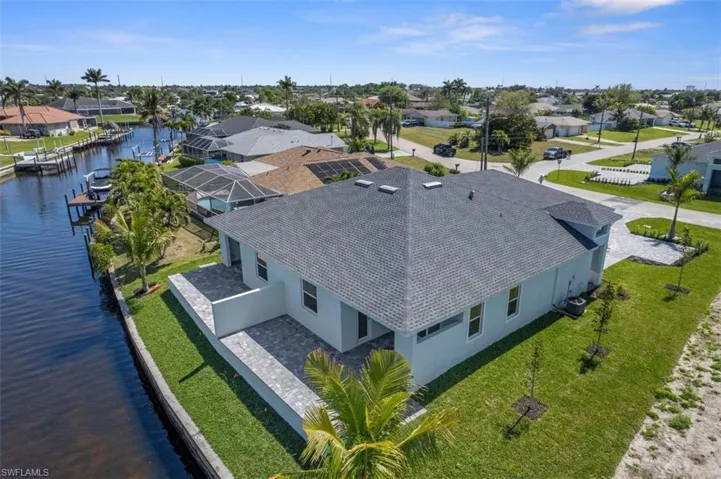 Birds eye view of property with a residential view and a water view