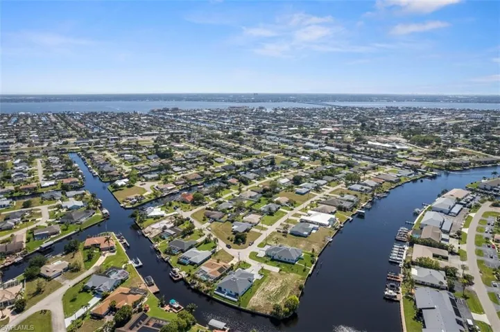 Birds eye view of property with a water view and a residential view