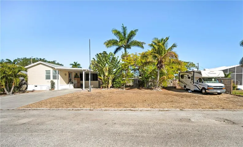 View of front of house with driveway and a carport
