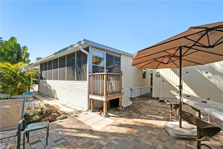 View of patio with a sunroom