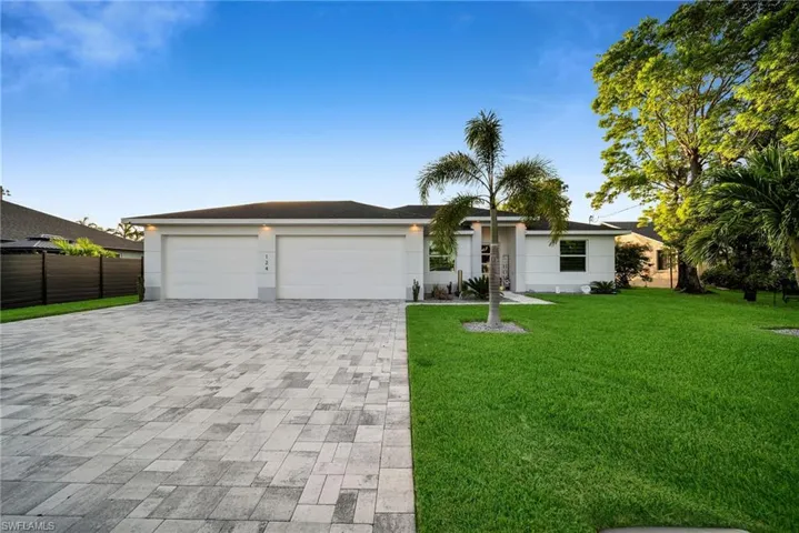 Ranch-style home featuring a garage and a front yard