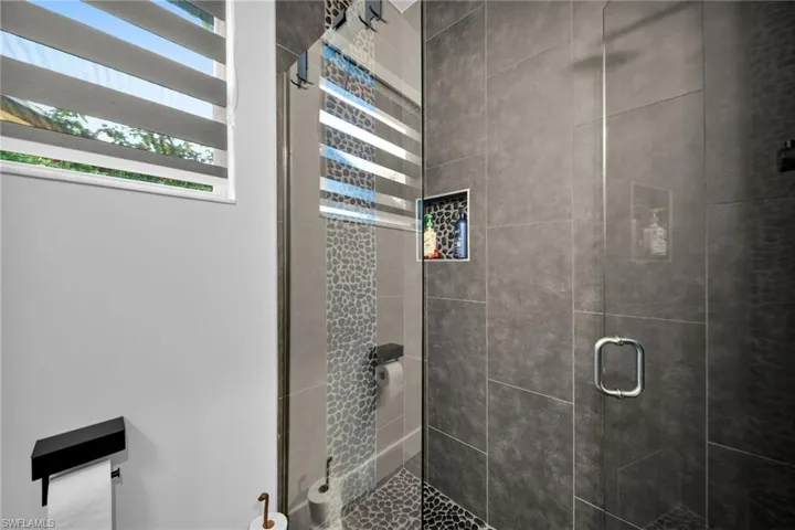 Bathroom featuring a shower with door