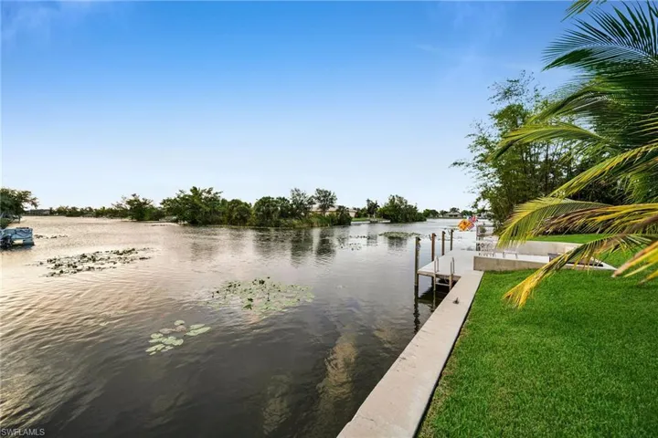 Dock area featuring a yard and a water view