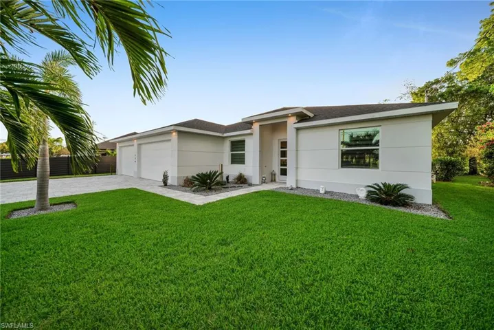 View of front of house with a garage and a front yard