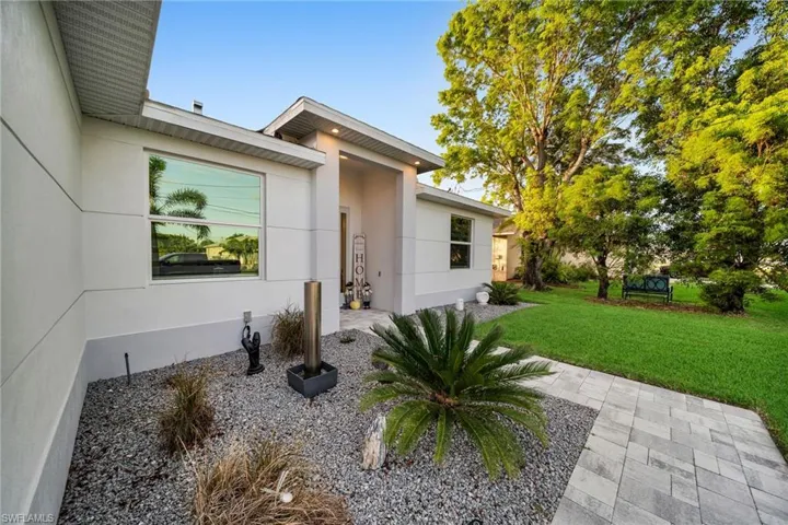 Doorway to property with a yard