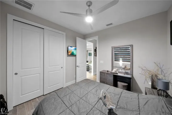 Bedroom featuring ceiling fan, a closet, and light hardwood / wood-style flooring