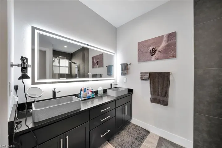 Bathroom featuring a shower with door, vanity, and hardwood / wood-style flooring