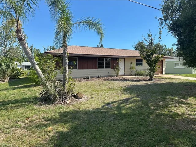 Ranch-style home with one car garage.  Waterfront with seawall, dock & boatlift