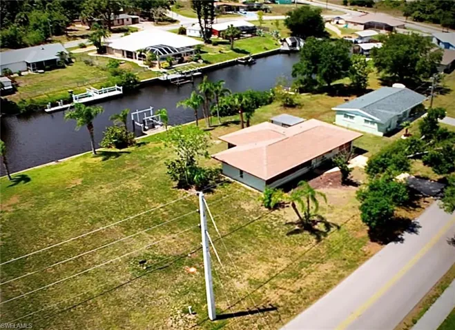 View of home plus extra lot.  Seawall and dock.  Boat your way to the Gulf.