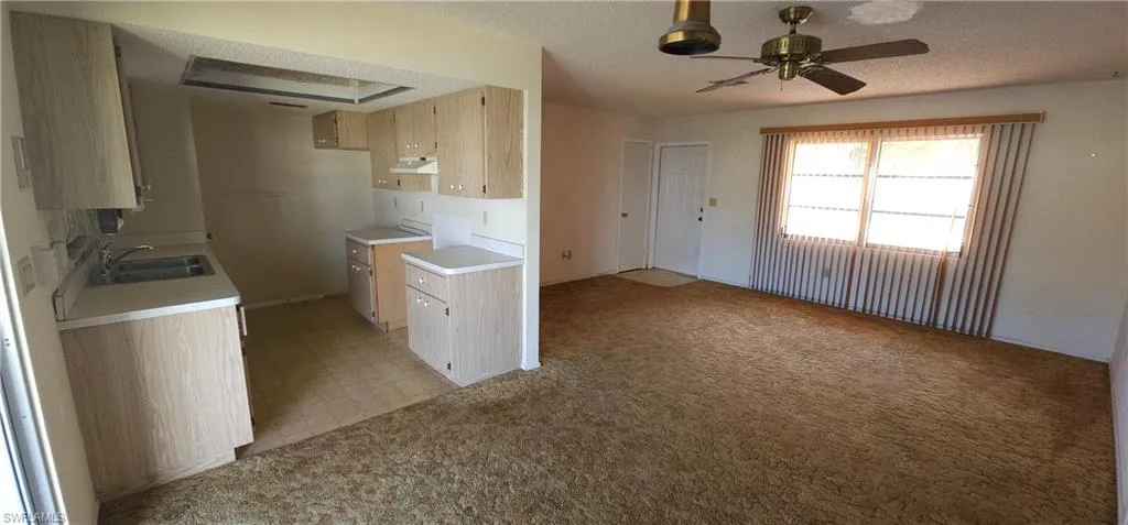 View of living room, dining area and kitchen