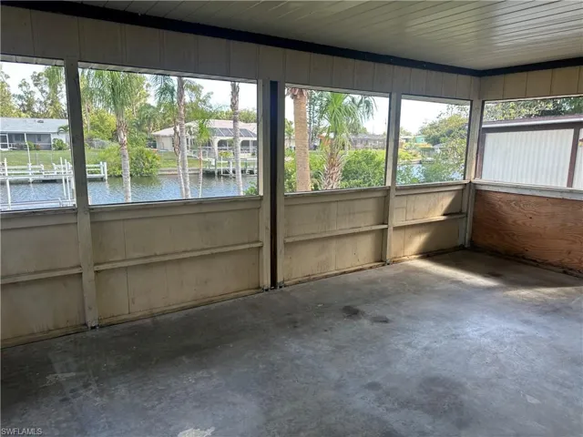 Unfurnished sunroom with a water view