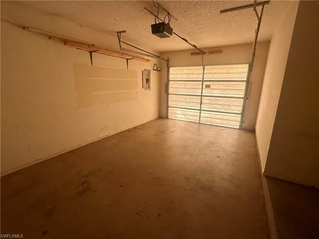Garage featuring a garage door opener.