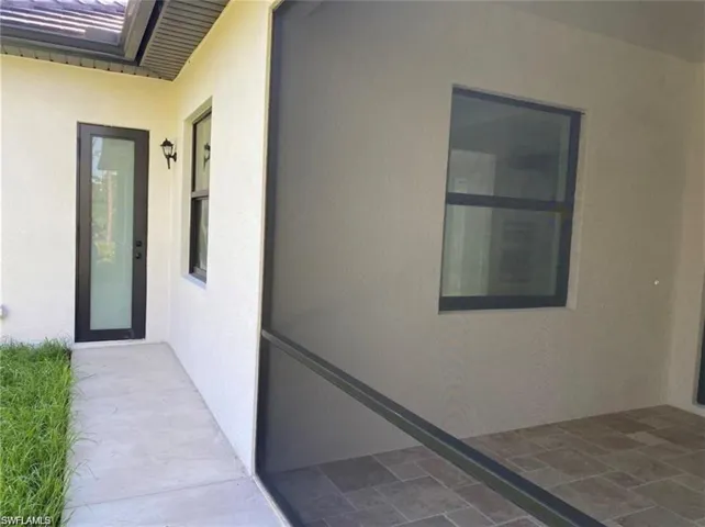 View of exterior entry featuring stucco siding