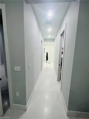 Corridor featuring baseboards