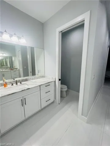 Bathroom featuring vanity and toilet