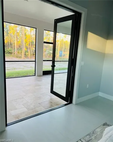 Doorway featuring baseboards
