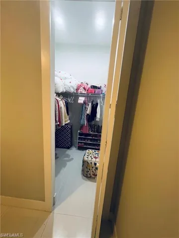 Spacious closet with light tile patterned flooring