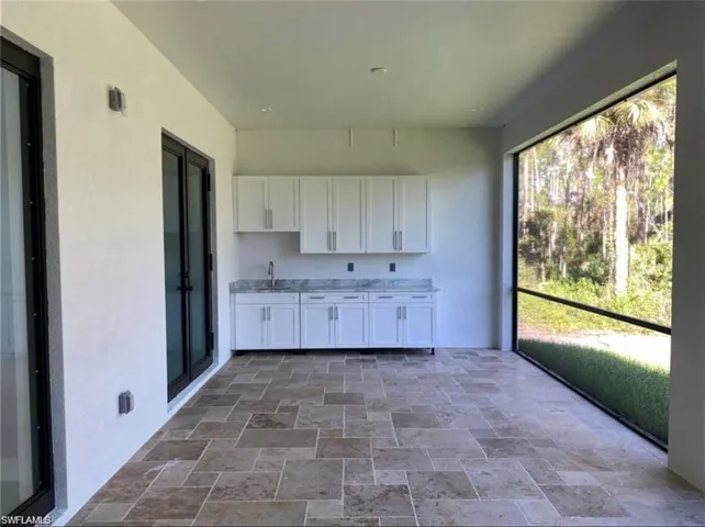 Unfurnished sunroom featuring a sink