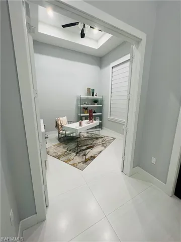 Home office featuring baseboards and a ceiling fan