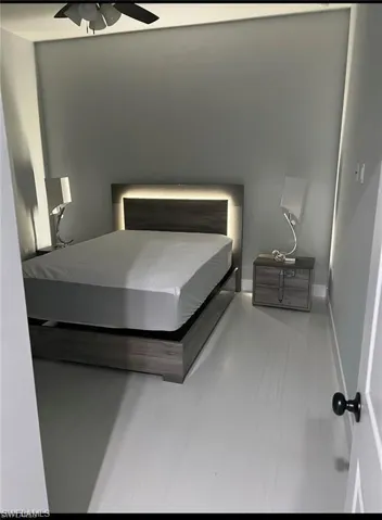 Bedroom with a ceiling fan and baseboards