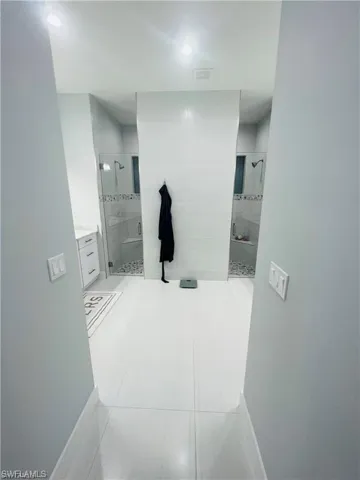 Bathroom with vanity and a stall shower