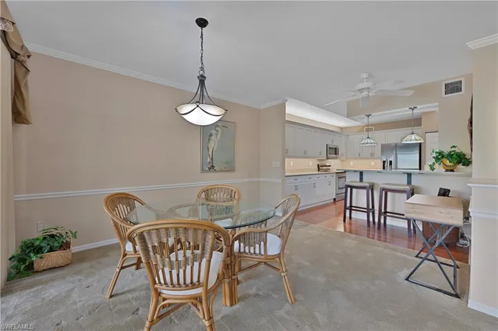 Dining room featuring crown molding, ceiling fan, and light hardwood / wood-style flooring