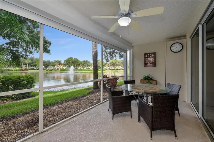 Sunroom / solarium with ceiling fan, a water view, and a wealth of natural light