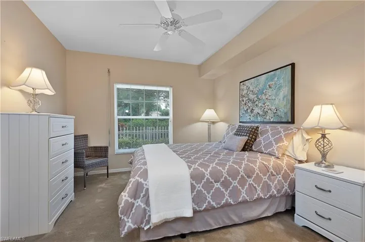 Carpeted bedroom with ceiling fan