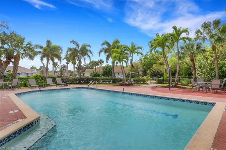 Community pool featuring a patio and outdoor dining space