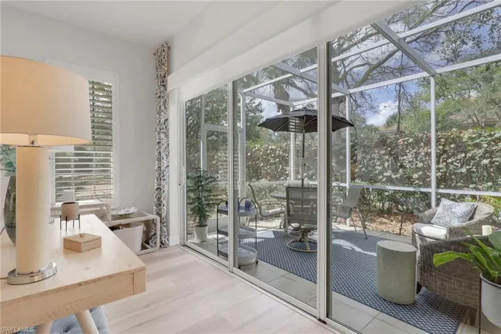 Entryway featuring a sunroom and wood finished floors