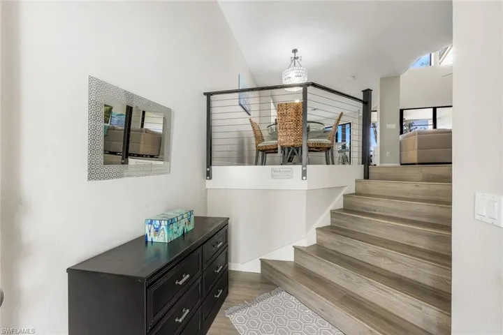 Cozy entry hall with newly installed modern cable staircase railings.