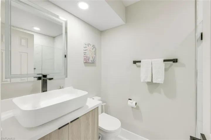 Newly renovated bathroom with vanity and recessed lighting