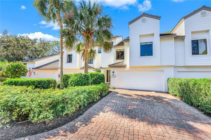 View of front of home featuring decorative driveway and an attached garage