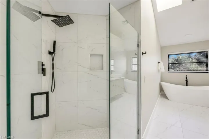 Newly updated primary bathroom with marble shower and flooring.