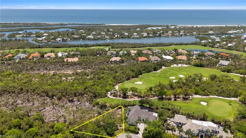 Aerial perspective of suburban area with a golf club, a nearby body of water, and property boundaries highlighted
