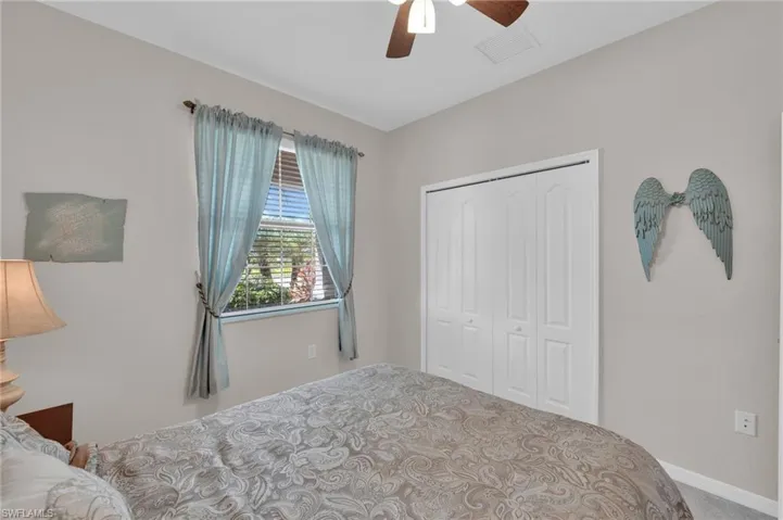 Bedroom with a ceiling fan, a closet, and carpet flooring