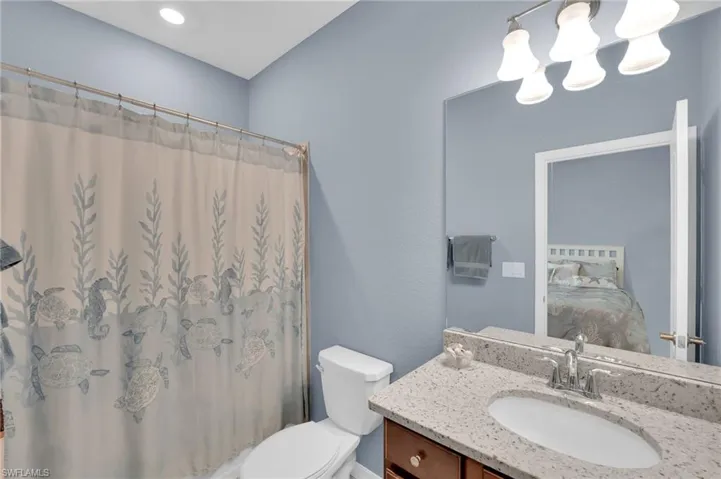 Full bathroom featuring vanity, connected bathroom, and a chandelier
