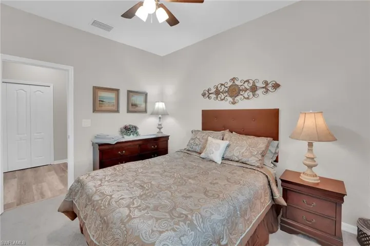 Bedroom with light carpet and ceiling fan