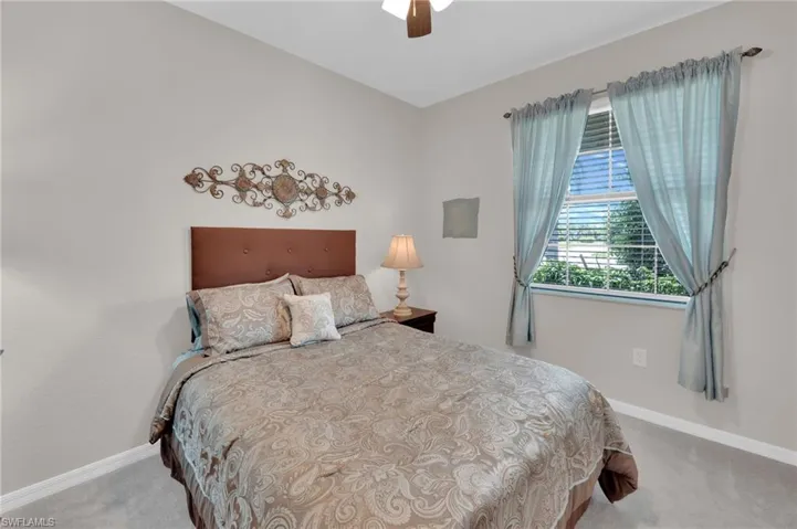 Bedroom with light carpet and ceiling fan