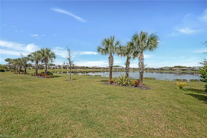 View of green lawn with a water view