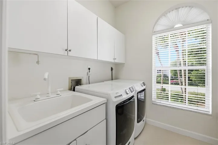 Laundry room featuring cabinet space and washing machine and clothes dryer