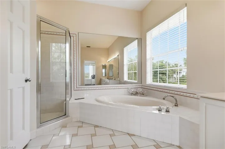 Full bathroom with a bath, a shower stall, and vanity