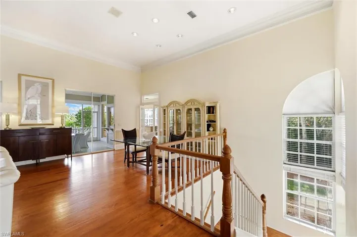 Hall featuring an upstairs landing, crown molding, and light wood-style floors