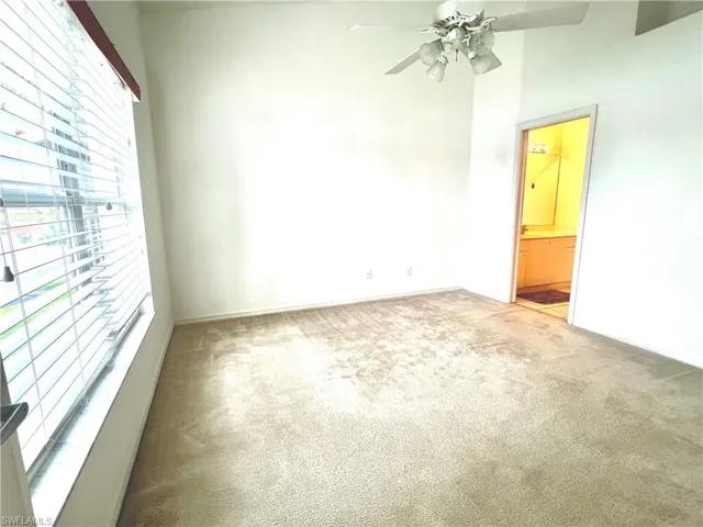 Spare room featuring carpet flooring and ceiling fan