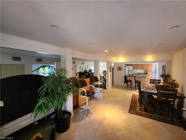Downstairs Living area featuring recessed lighting and light tile patterned flooring