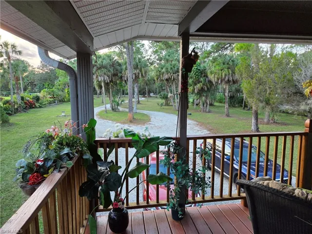 Deck with a yard and view of scattered trees
