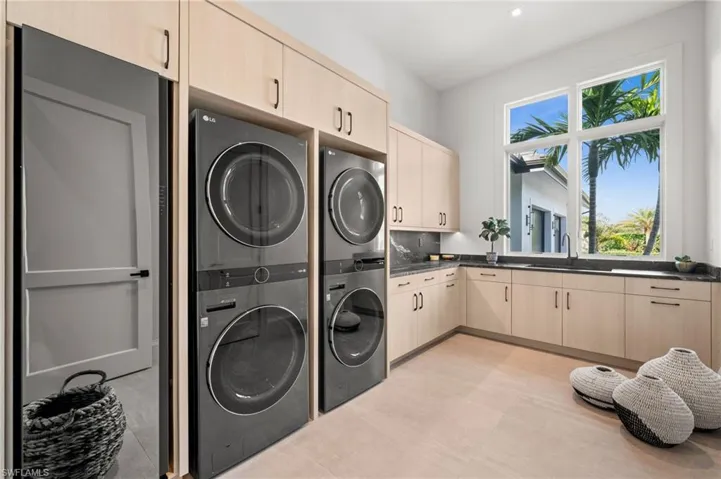 Laundry area with cabinet space and estacked washer and dryer
