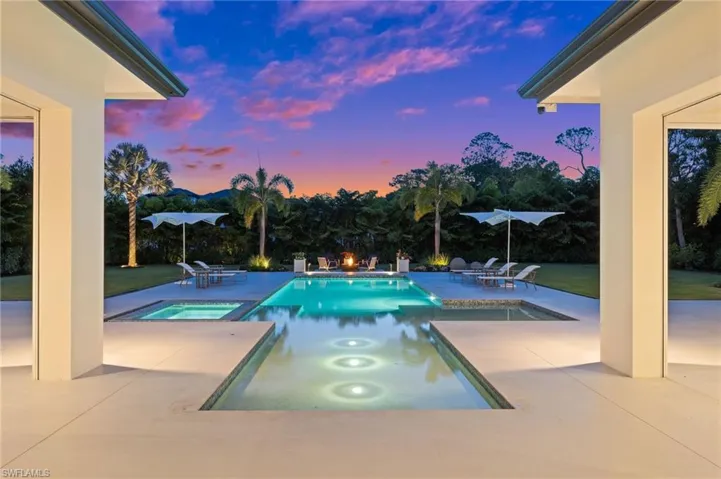 View of swimming pool featuring a patio and a pool with connected hot tub
