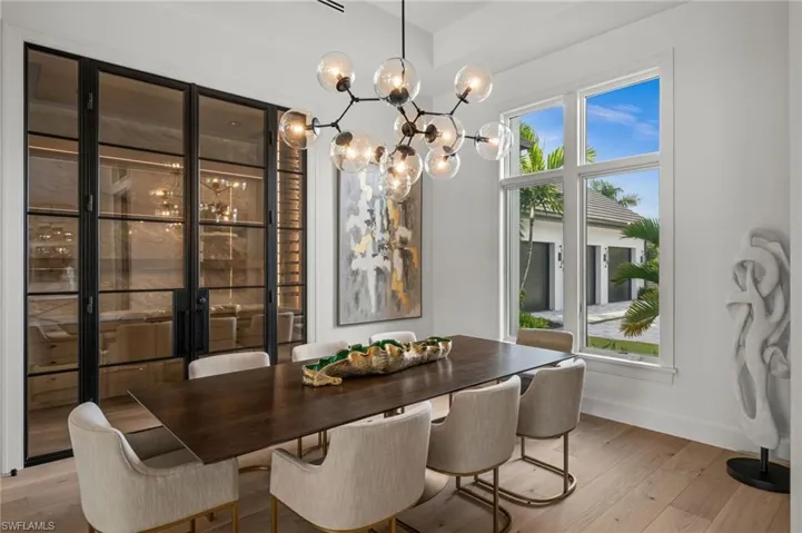 Dining space with wood finished floors, baseboards, and a chandelier
