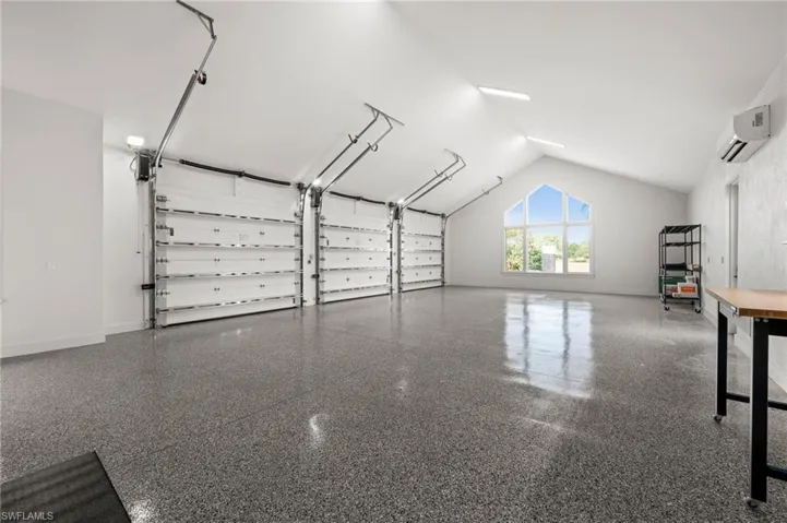 Garage #1 of 2 featuring a wall unit AC and baseboards